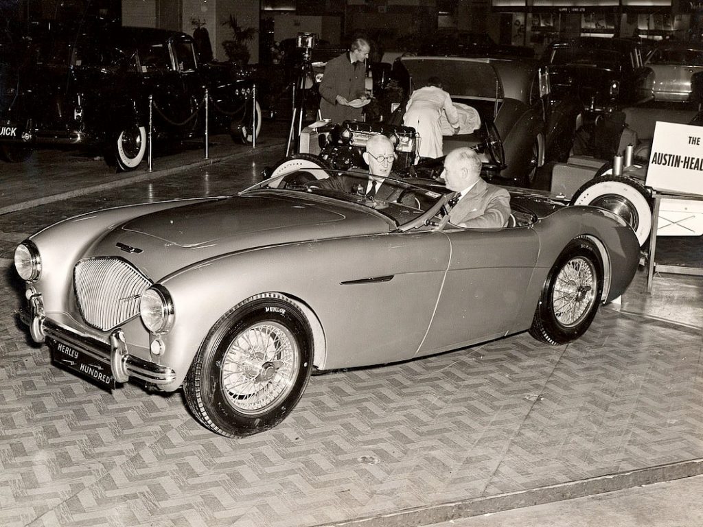 Leonard Lord and Donald Healey sitting in the Healey Hundred at the 1952 London Motorshow