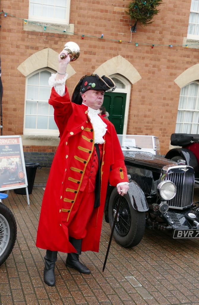 Stony Stratford's Town Crier announcing one minute of "noise" to celebrate the New Year.