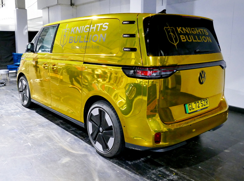 Volkswagen ID. Buzz van in stunning metallic gold. Rear.